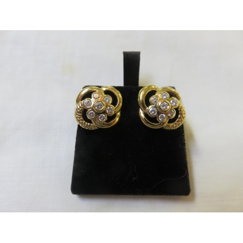 54 - Pair of 18ct gold seven stone diamond earrings