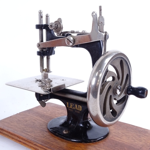 A Vintage Japanese portable Lead sewing machine, in bentwood travelling