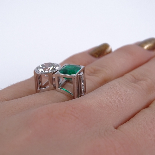 1105 - A 2-stone emerald and diamond ring, set with an octagonal emerald within a square surround and a col... 
