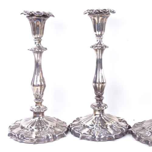 1633 - A set of 4 Victorian silver table candlesticks, shaped form with acanthus leaf decoration and remove... 