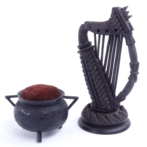 56 - A Victorian Irish bog oak harp, and a pin cushion cauldron, harp height 14cm.