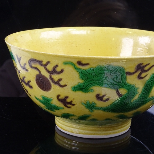 57 - A Chinese yellow-ground Dragon bowl, depicting dragons chasing a flaming pearl, 6 character Kangxi m... 