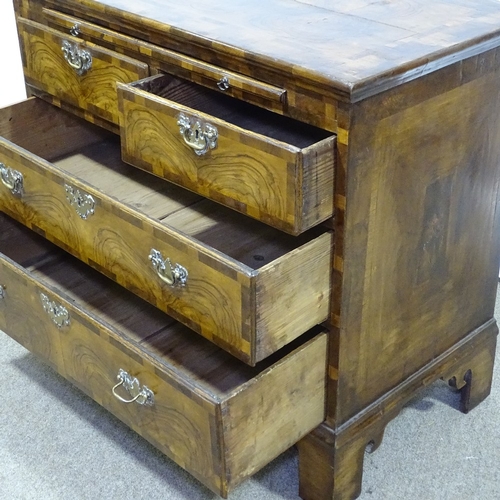 151 - An 18th century figured walnut bachelor's chest of drawers, with brushing slide, ornate multi-panel ... 