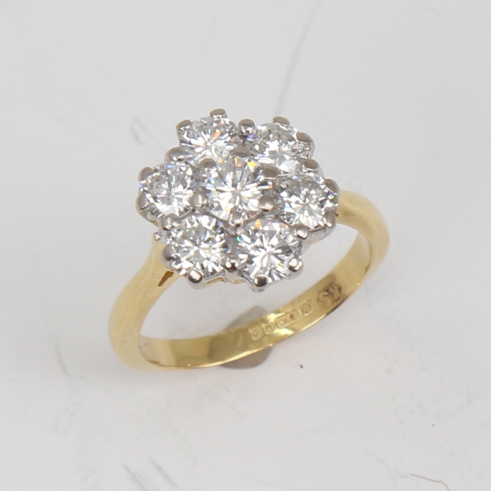 A late 20th century 18ct gold 7-stone diamond cluster flowerhead ring