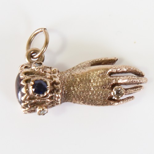 67 - A late 20th century 9ct gold gem-set figural hand charm, set with cabochon garnet, sapphires and dia... 