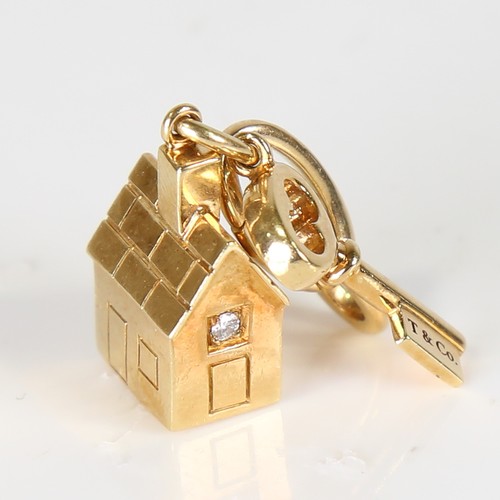 72 - TIFFANY & CO - a modern 18ct gold diamond house and key charm/pendant, window set with modern round ... 