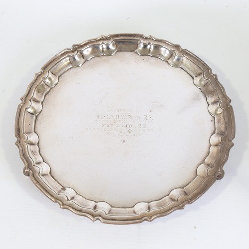 78 - A George V silver salver, circular form with scalloped rim raised on three acanthus leaf feet, with ... 