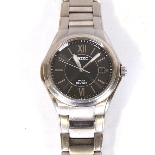 16 - SEIKO - a titanium Solar quartz wristwatch, ref. V145-0BA0, black dial with steel baton hour markers... 
