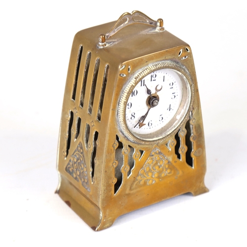 18 - A German Arts and Crafts brass-cased alarm clock, white enamel dial with Arabic numerals and pierced... 