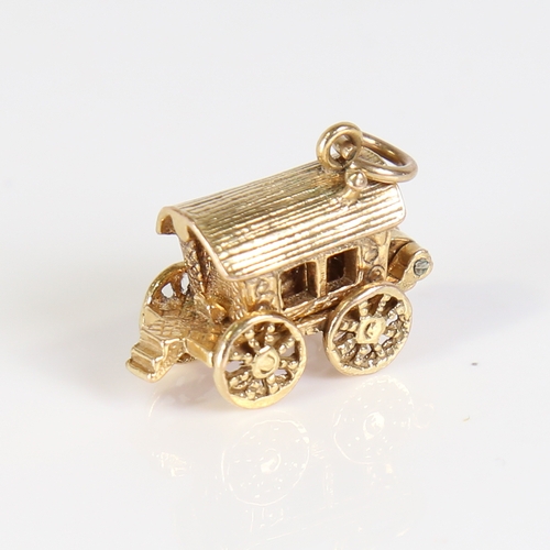 68 - A late 20th century 9ct gold Gypsy caravan charm, opening to reveal a fortune teller with crystal ba... 