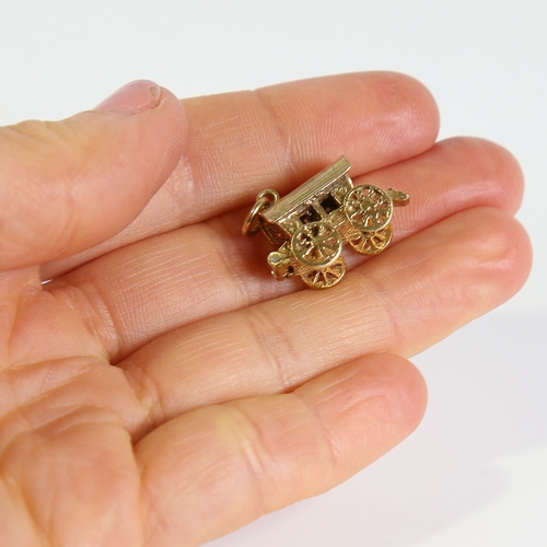 68 - A late 20th century 9ct gold Gypsy caravan charm, opening to reveal a fortune teller with crystal ba... 