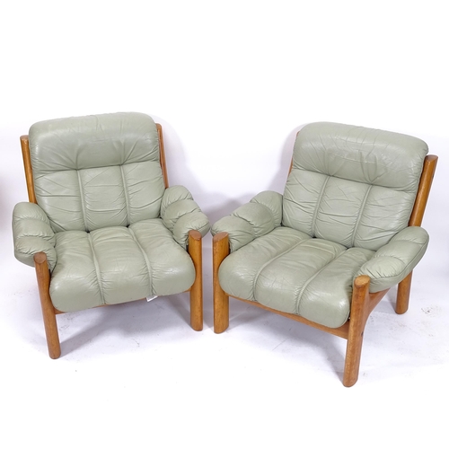 2015 - A pair of mid-century leather-upholstered lounge chairs, width overall 88cm, H80cm, depth overall 90... 