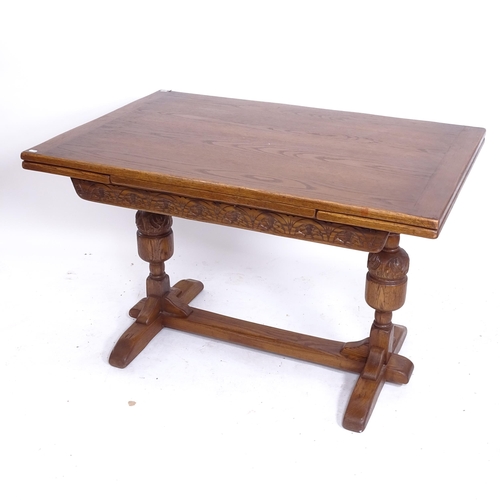 2037 - An oak draw leaf table with carved frieze, and baluster legs, W122cm extending to 182cm, H77cm, D82c... 