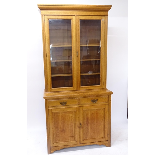 2040 - A Victorian golden oak 2-section library bookcase, lower section having 2 fitted drawers and cupboar... 