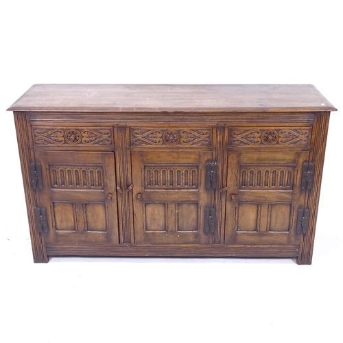 2044 - A 1920s oak sideboard with 3 carved frieze drawers, and 3 panelled doors, W153cm, H87cm, D46cm