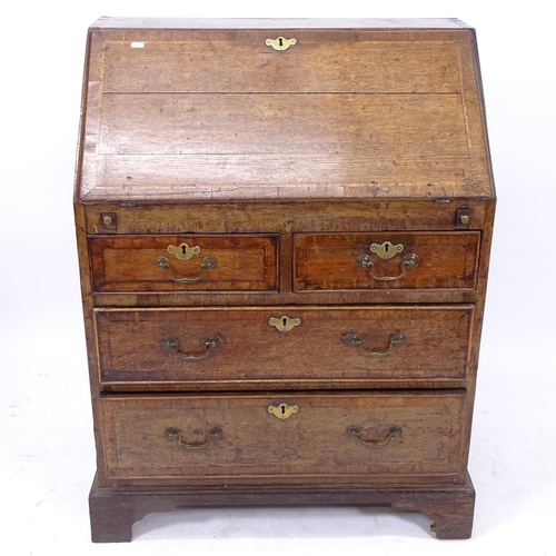 2050 - A George III crossbanded oak bureau, the fall-front revealing a 3-stepped pigeon hole and drawer int... 