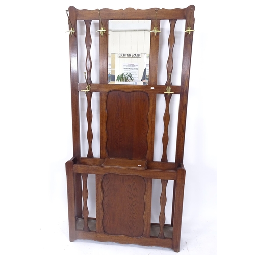 2057 - A 1920s panelled oak mirror-back hallstand, W93cm, H188cm