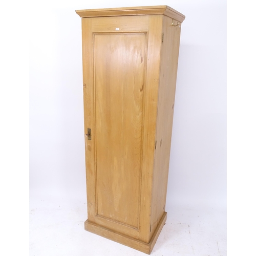 2061 - A pine hall cupboard with single panelled door, and key, W64cm, H181cm, D49cm