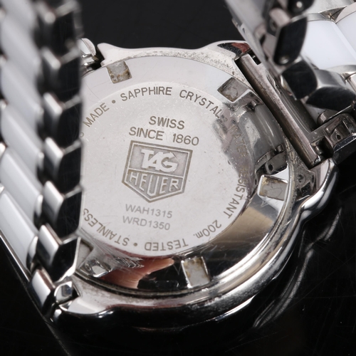 37 - TAG HEUER - a lady's stainless steel and white ceramic Formula 1 quartz bracelet watch, ref. WAH1315... 