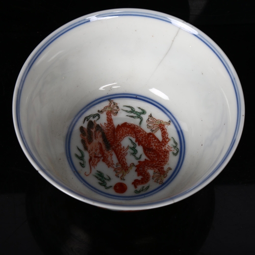 448 - A Chinese Doucai 'dragon and phoenix' porcelain bowl, depicting 5-claw dragon chasing flaming pearl,... 
