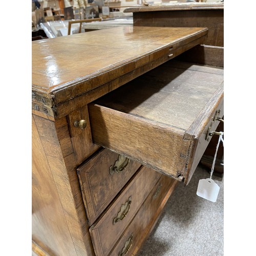 1269 - An early 18th century walnut bachelor's chest of 4 long graduated drawers of small size, with crossb... 