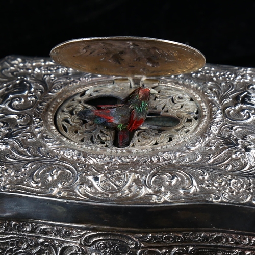 400 - A 20th century German silver singing bird automaton music box, serpentine form with relief embossed ... 