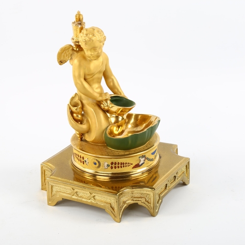 1036 - A Continental gilded porcelain posy holder, in the form of Eros holding a shell, having a stopper fo... 