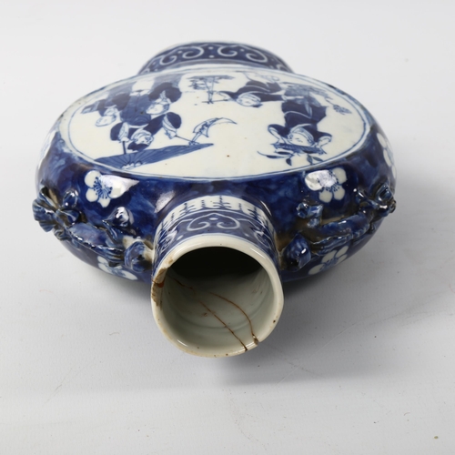 1045 - A Chinese blue and white porcelain moon-shaped vase, with painted panels, height 22cm, rim broken an... 