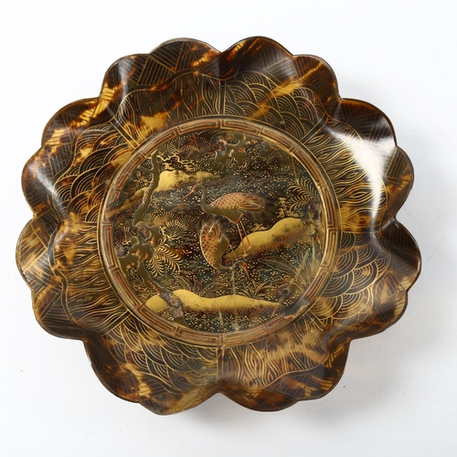 1046 - A 19th century Japanese tortoiseshell dish of scalloped circular form, relief moulded gold lacquer c... 