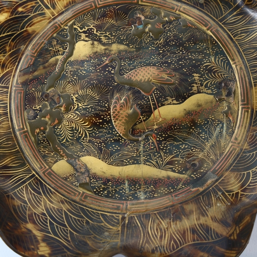 1046 - A 19th century Japanese tortoiseshell dish of scalloped circular form, relief moulded gold lacquer c... 