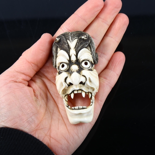 1053 - A Japanese ivory okimono, in the form of a Noh mask, Meiji Period, circa 1900, length 7.5cm