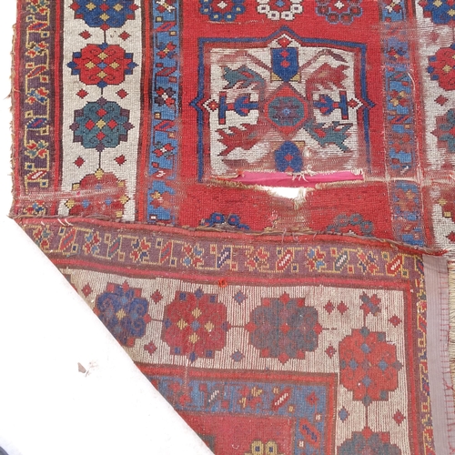 2391 - An Antique red ground Turkish Kazak rug (for restoration), L214cm