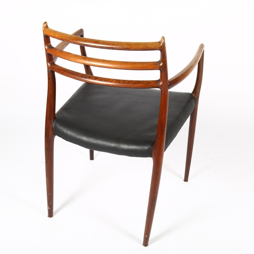 1509 - NIELS OTTO MOLLER for JL MOLLER, a Model 62 rosewood dining armchair chairs, designed 1962, with bla... 