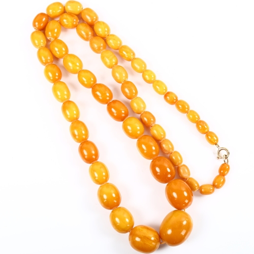 178 - A long graduated single-strand butterscotch amber bead necklace, beads ranging from 28.1mm to 9.8mm,... 