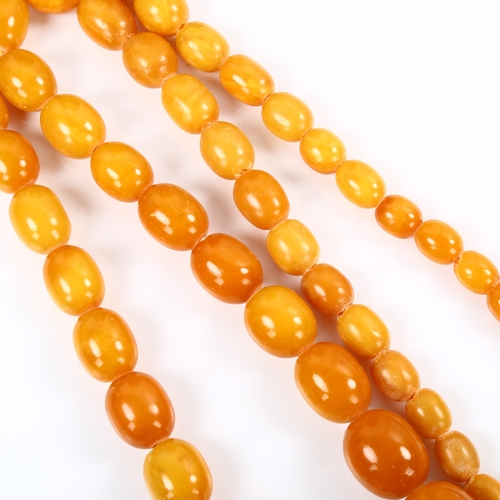 178 - A long graduated single-strand butterscotch amber bead necklace, beads ranging from 28.1mm to 9.8mm,... 