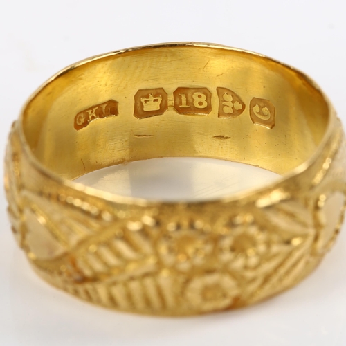 191 - An early 20th century 18ct gold wedding band ring, with chased flower and heart decoration, maker's ... 