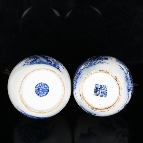 1022 - 2 Chinese blue and white opium pipe pots, with metal mounts and marks on bases, height excluding han... 