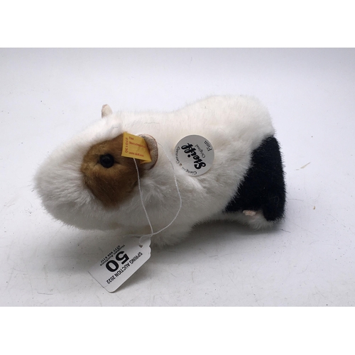 50 - Steiff Animal with original label and ear pin, seated black and white Hamster, called Finn