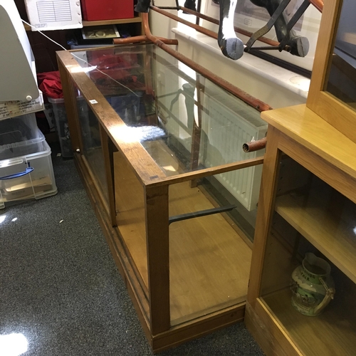 18 - Edwardian period glass shops show cabinet, oak c1920's 5'6 long 2'6 deep with single sliding glass d... 