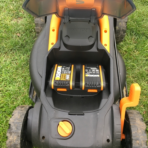 25 - Almost new used 3 time cordless electric lawn mower with 2 batteries and charger , plus grass box mo... 