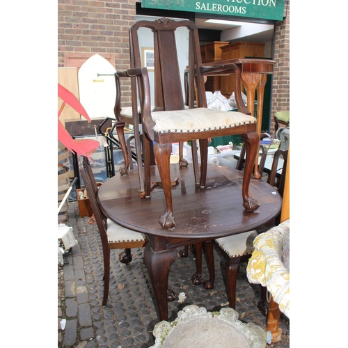 41 - Oval Edwardian Mahogany wind out table and a set of chairs