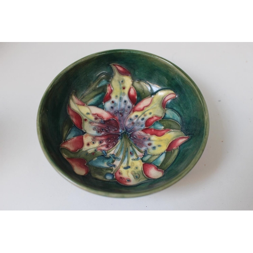 55 - Moorcroft Nut dish with floral decoration on green ground with impressed mark to base