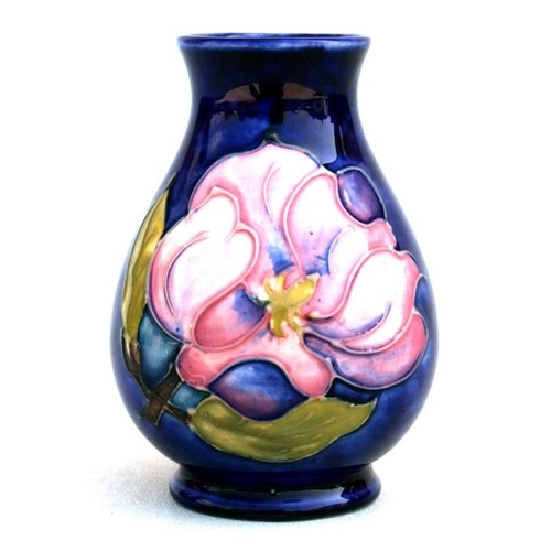 An Unsigned Moorcroft Vase Decorated With Pink Flowers On A Blue