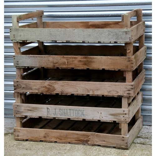 A group of five wooden apple crates.