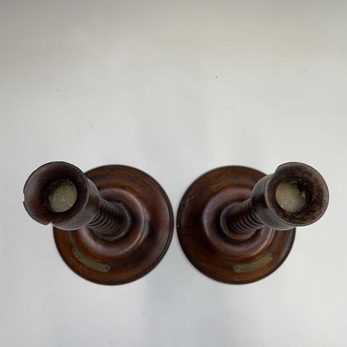 9 - A pair of 20th century turned teak candlesticks, each bearing a brass plaque inscribed 'MADE FROM TI... 