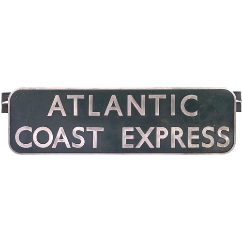 A BR(S) locomotive headboard, ATLANTIC COAST EXPRESS, carried on the principal service from Waterloo to the West of England. The title was introduced by the Southern Railway in July 1926 and this style of headboard, designed to be carried by Bulleid Pacifics, was used from the summer of 1953 until its last titled run in September 1964. The most multi-portioned express in the country, it had coaches for numerous holiday resorts in Devon and Cornwall. Cast aluminium, 60"x15", the front repainted. (Postage Band: N/A)