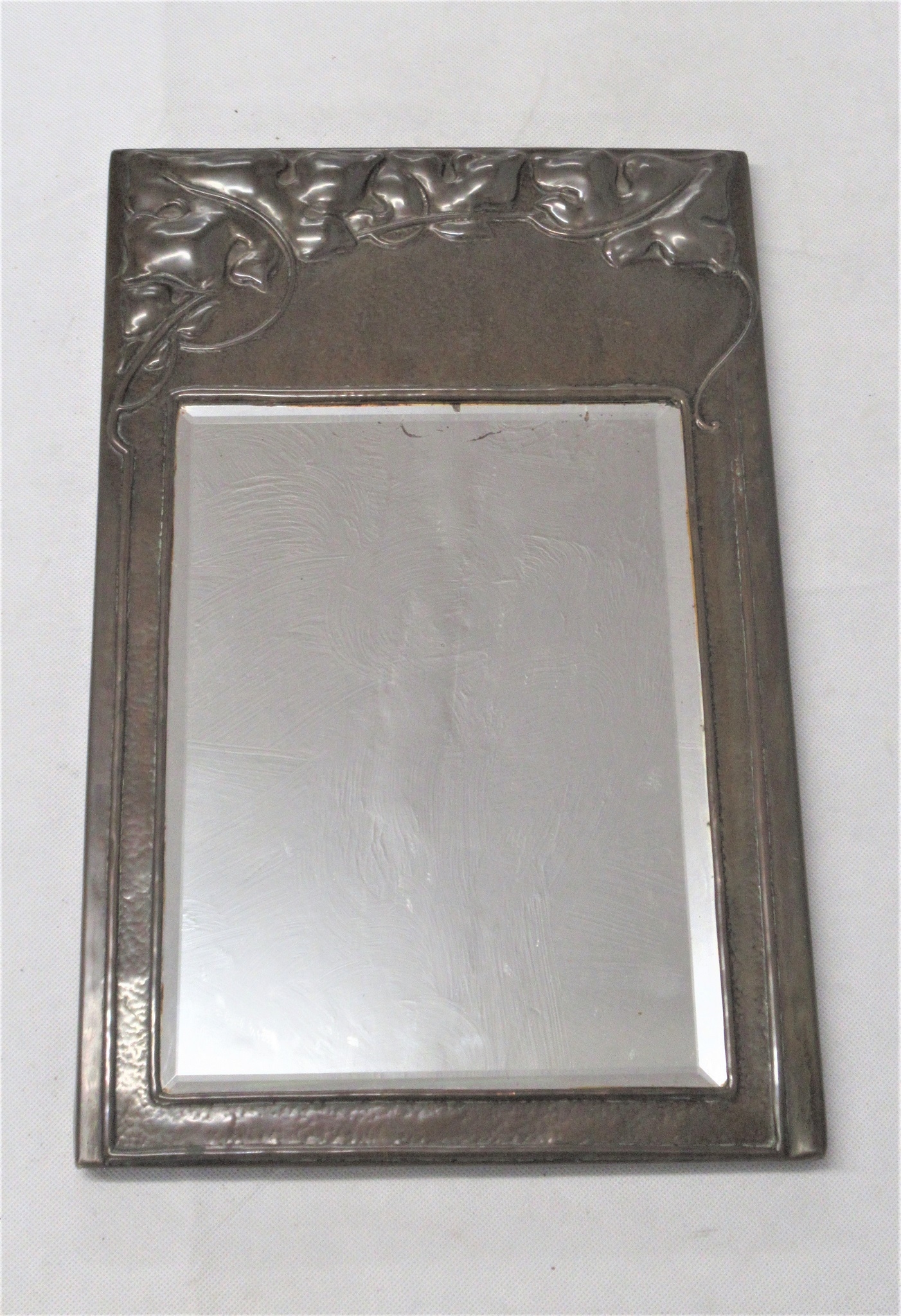 An 'Art Nouveau' Hand Hammered Copper Mirror, Set with bevelled glass ...
