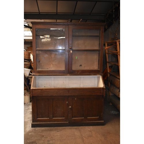 163 - An oak school cupboard with glazed doors                 


Subject to VAT