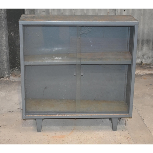 7 - A glass front metal cupboard                                       

Subject to VAT