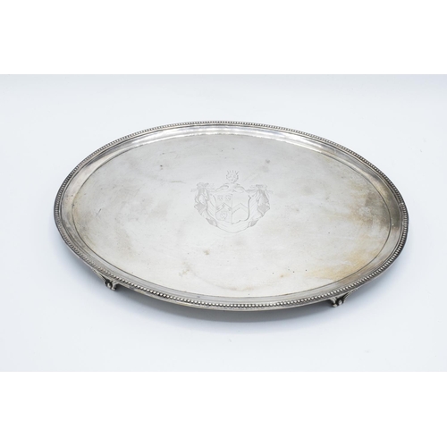 221 - Georgian silver oval salver with an armorial crest decoration: hallmarked for London 1785 (694 grams... 